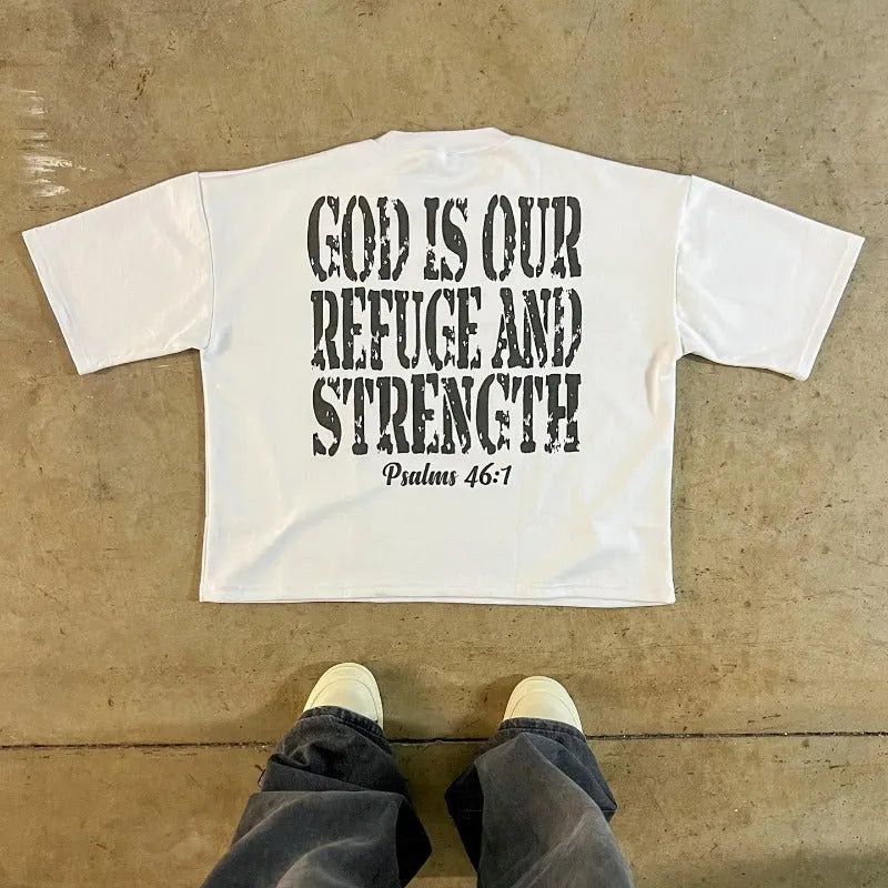 Man wearing a printed retro style cotton t-shirt with drop shoulder sleeves in a graphic design.