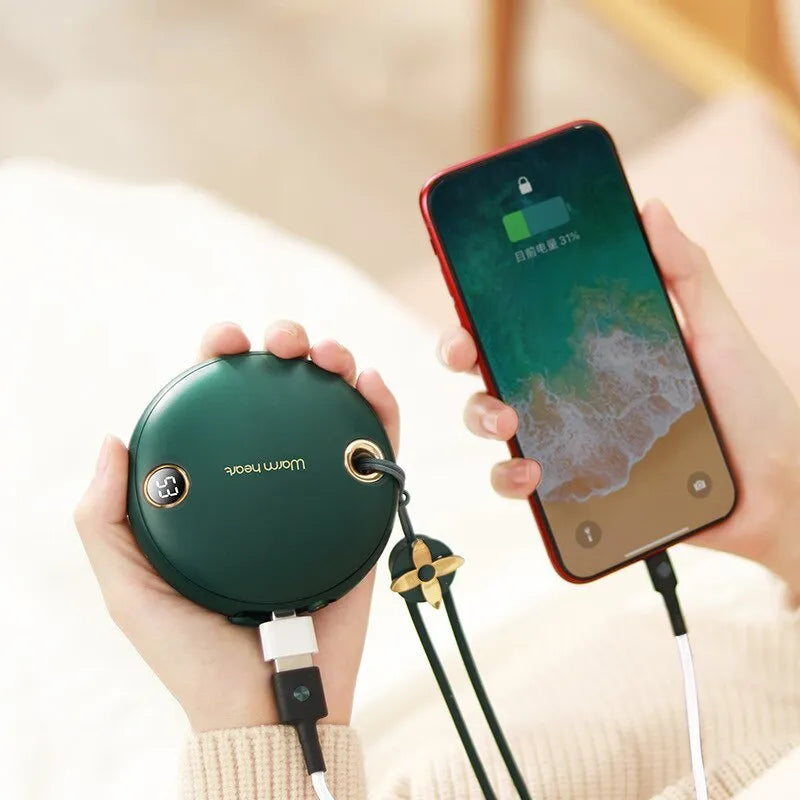 Green Pink or White coloured 5000mAh hand warmer power bank with digital display showing charge level.