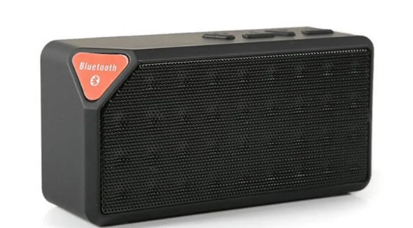Cannon X3 small cube-shaped wireless Bluetooth portable speaker shown in one of five colours: black, blue, green, red, or yellow.