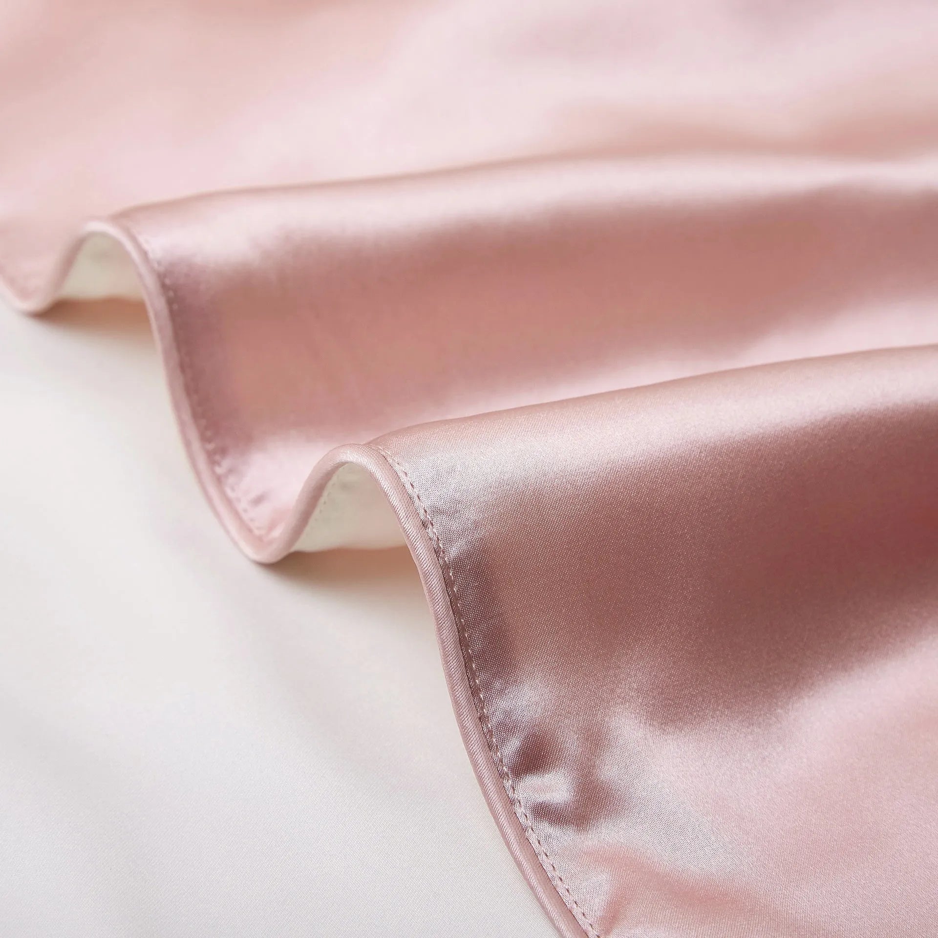 Single mulberry silk pillowcase in palace luxury style, shown in a selection of available colours.
