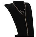 Multilayer lariat necklace in gold plated alloy on neutral background with visible 35cm and 45cm chain segments.