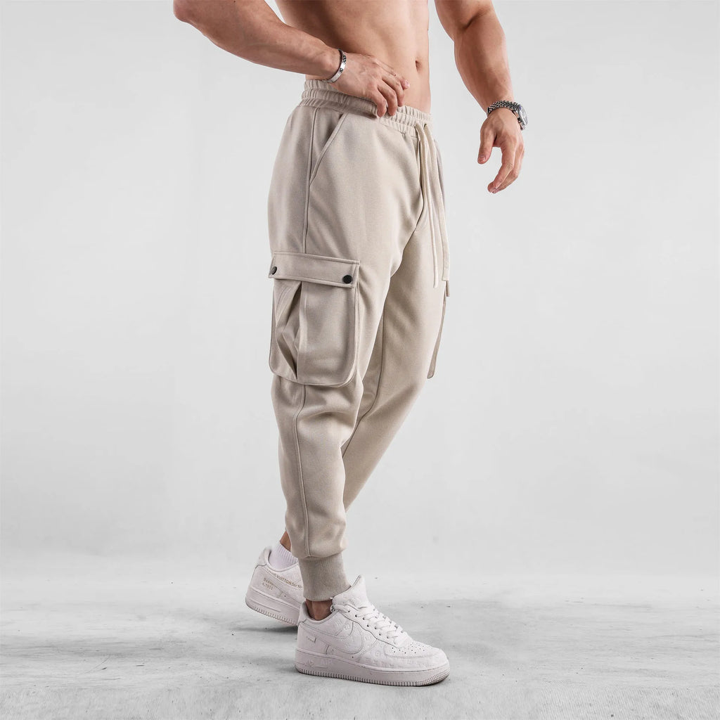 Men's loose-fit ankle-tied cotton sports trousers in solid colour with multi-pocket design