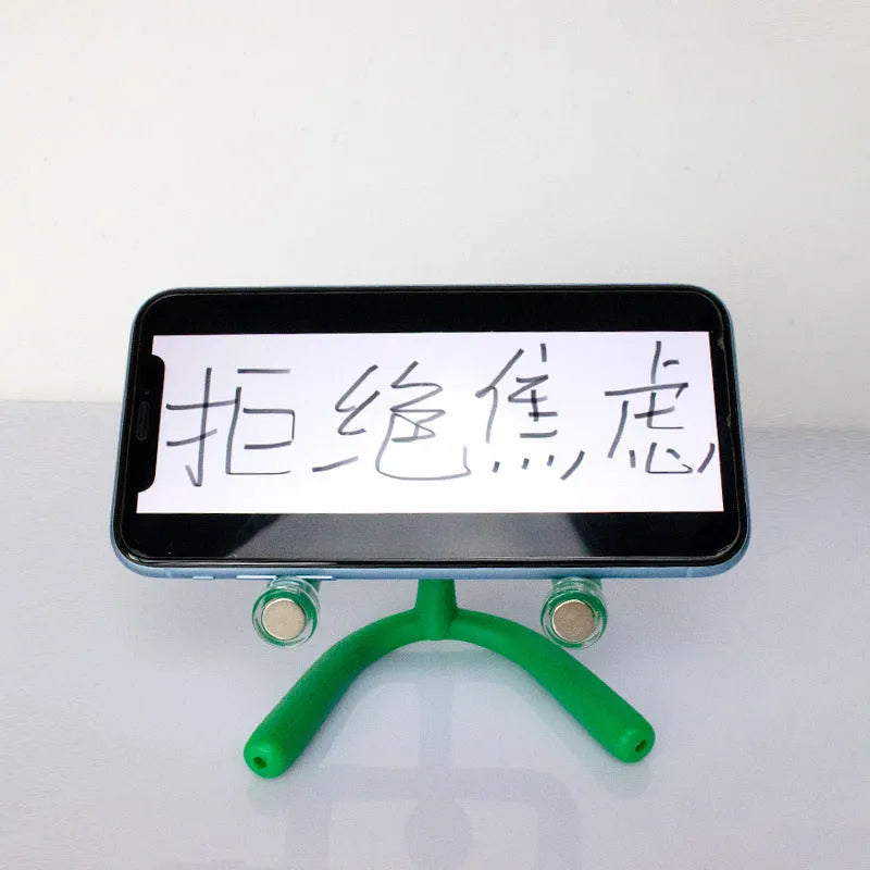 Small plastic decompression toy ornament in green with reject anxiety text, in iron box