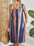 V-neck sleeveless dress with colour block stripes in a midi length, shown on a hanger.