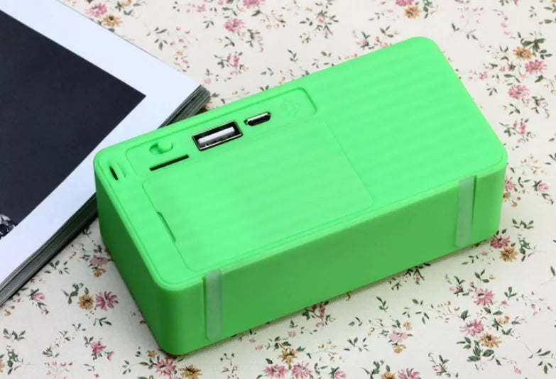 Cannon X3 small cube-shaped wireless Bluetooth portable speaker shown in one of five colours: black, blue, green, red, or yellow.