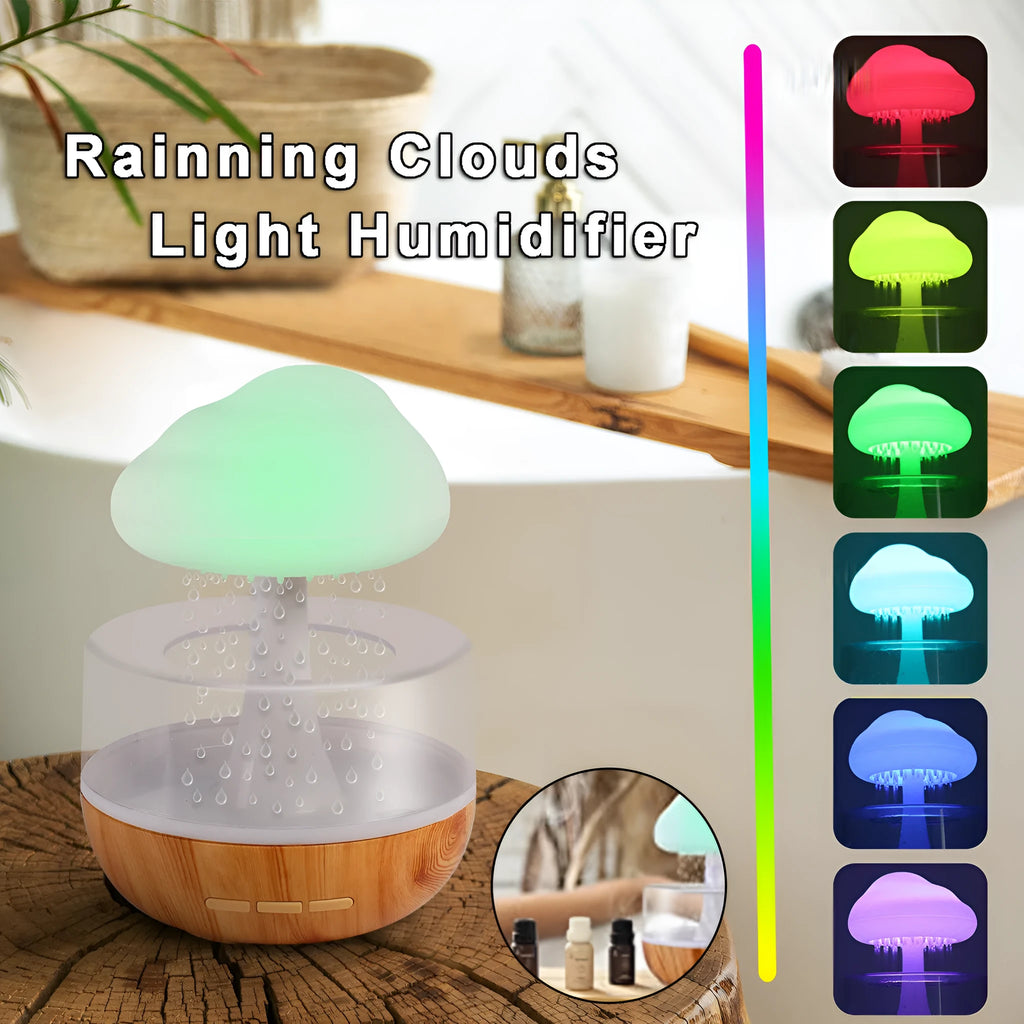 White cloud-shaped portable humidifier with coloured night light on a wooden table.