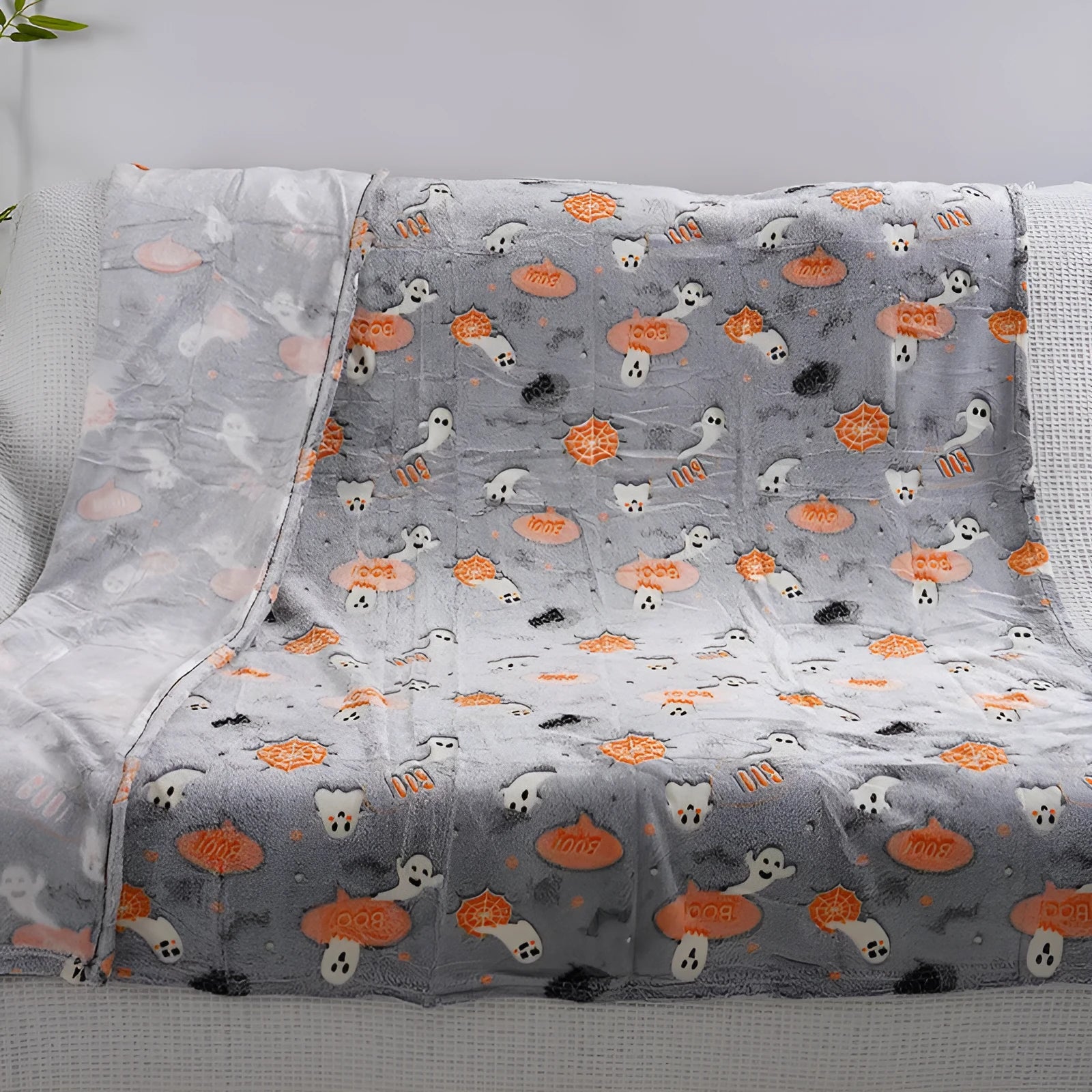 Cartoon patterned flannel blanket showing two size options for use as a child's blanket or air conditioner cover.