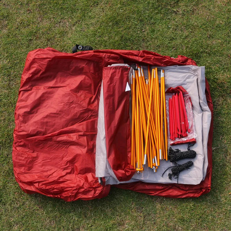 Grey outdoor multi-person tent with aluminum pole and nylon fabric set up on grass