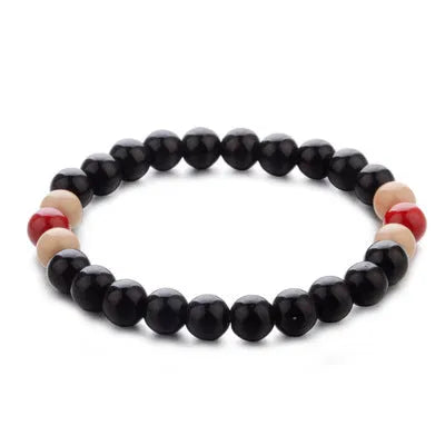 Natural stone bead bracelet with lava stones on a wrist, showing ethnic charm style and adjustable 18cm length.