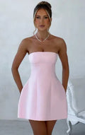 Women's short backless A-line tube dress in a solid colour on a model.