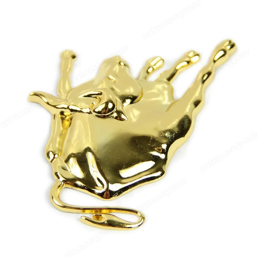 Gold metal car badge decal on a black car boot lid showing 3D profile