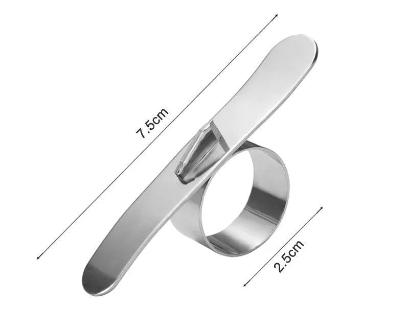 Stainless steel ring orange peeler on a countertop with citrus fruits nearby, showing compact silver tool