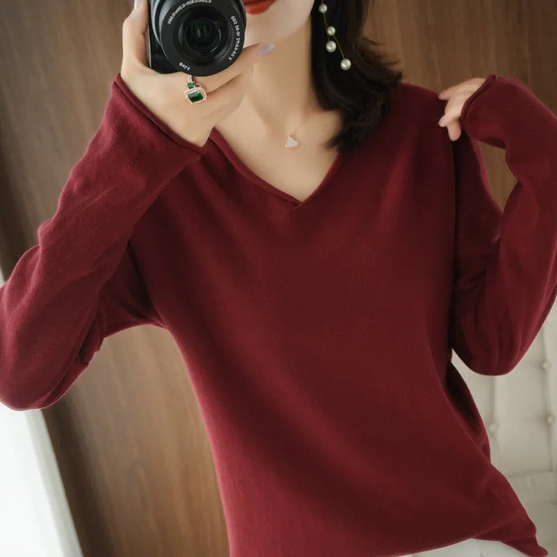 Women's grey V-neck long sleeve knitwear pullover on a hanger