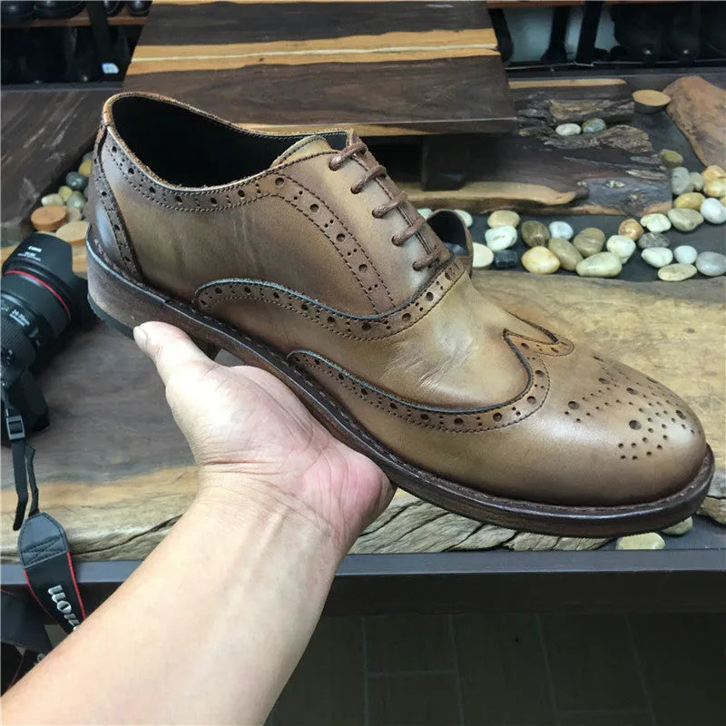 Light brown men's vintage engraved leather lace-up shoes with round toe.