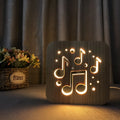 Square pine wood USB LED atmosphere lamp emitting warm white light from its 3D design.