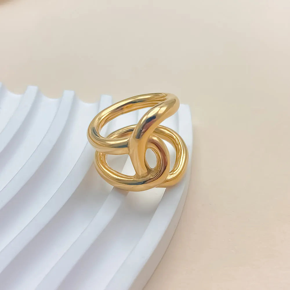 Adjustable stainless steel ring with knot design in U-shape, available in gold or steel colour