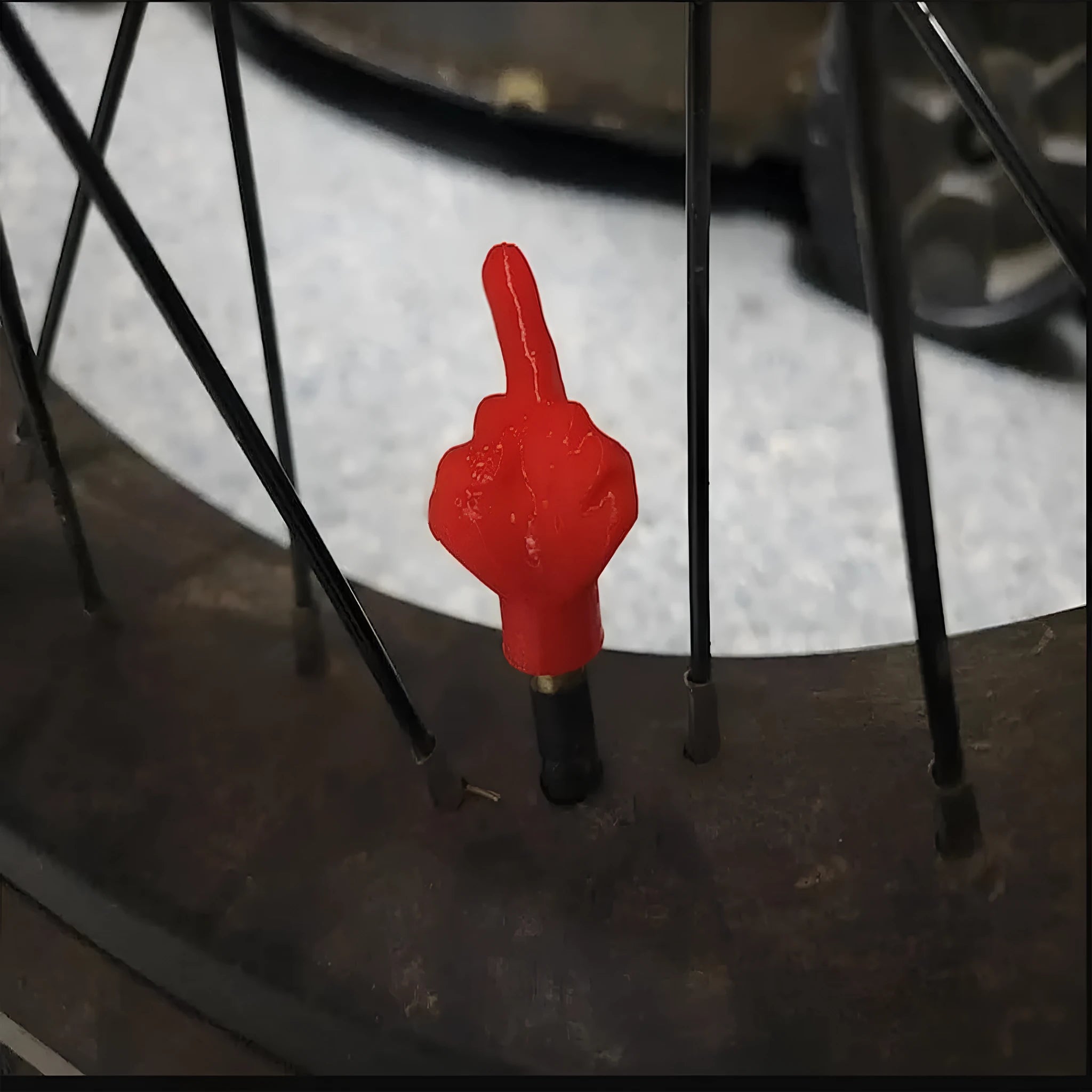 Set of four latex car tyre valve dust caps in black and skin colour tones.