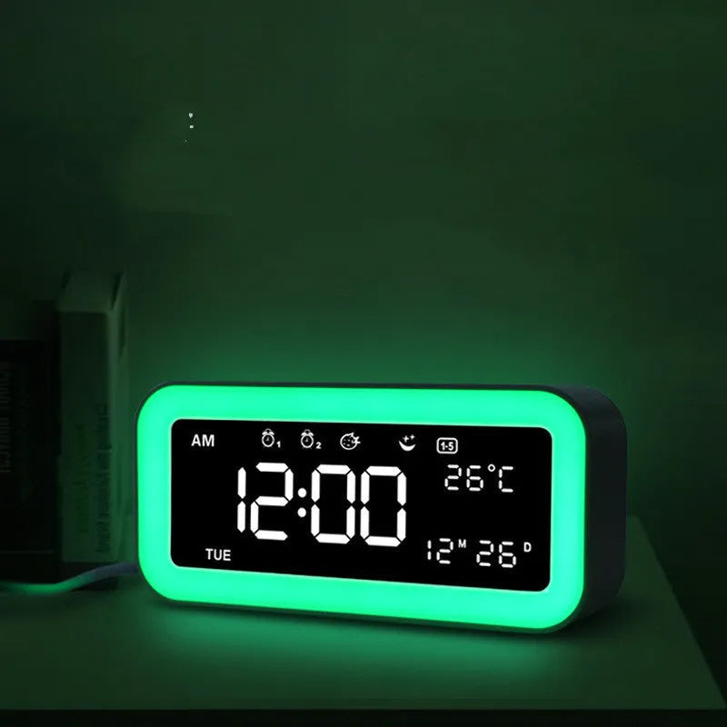 Blue rectangular LED multicoloured atmosphere light alarm clock with digital display on a desk.