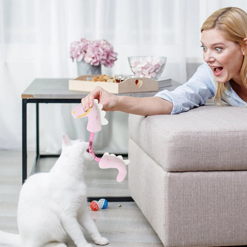 Set of four colourful cat toys including rope, springs, and plush kickers on a white background.