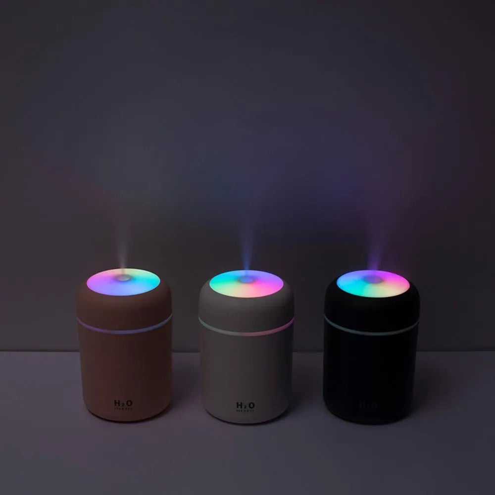 Pink USB portable humidifier with 300ml tank and colourful lights on a desk