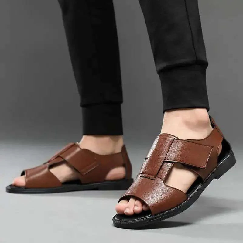 Men's black and brown Roman-style leather sandals with open-toe design and rubber soles