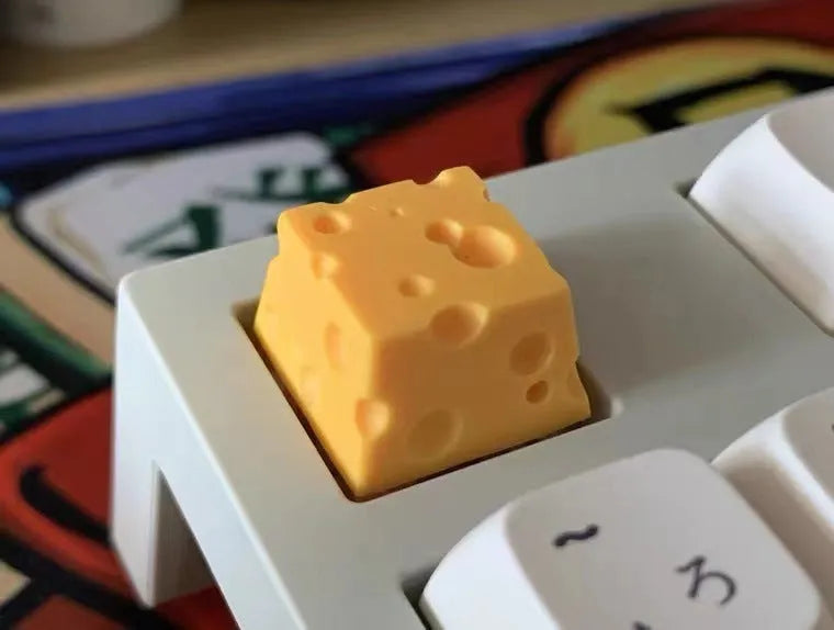 Yellow resin cheese wedge keycap for mechanical keyboards with MX stem mount.