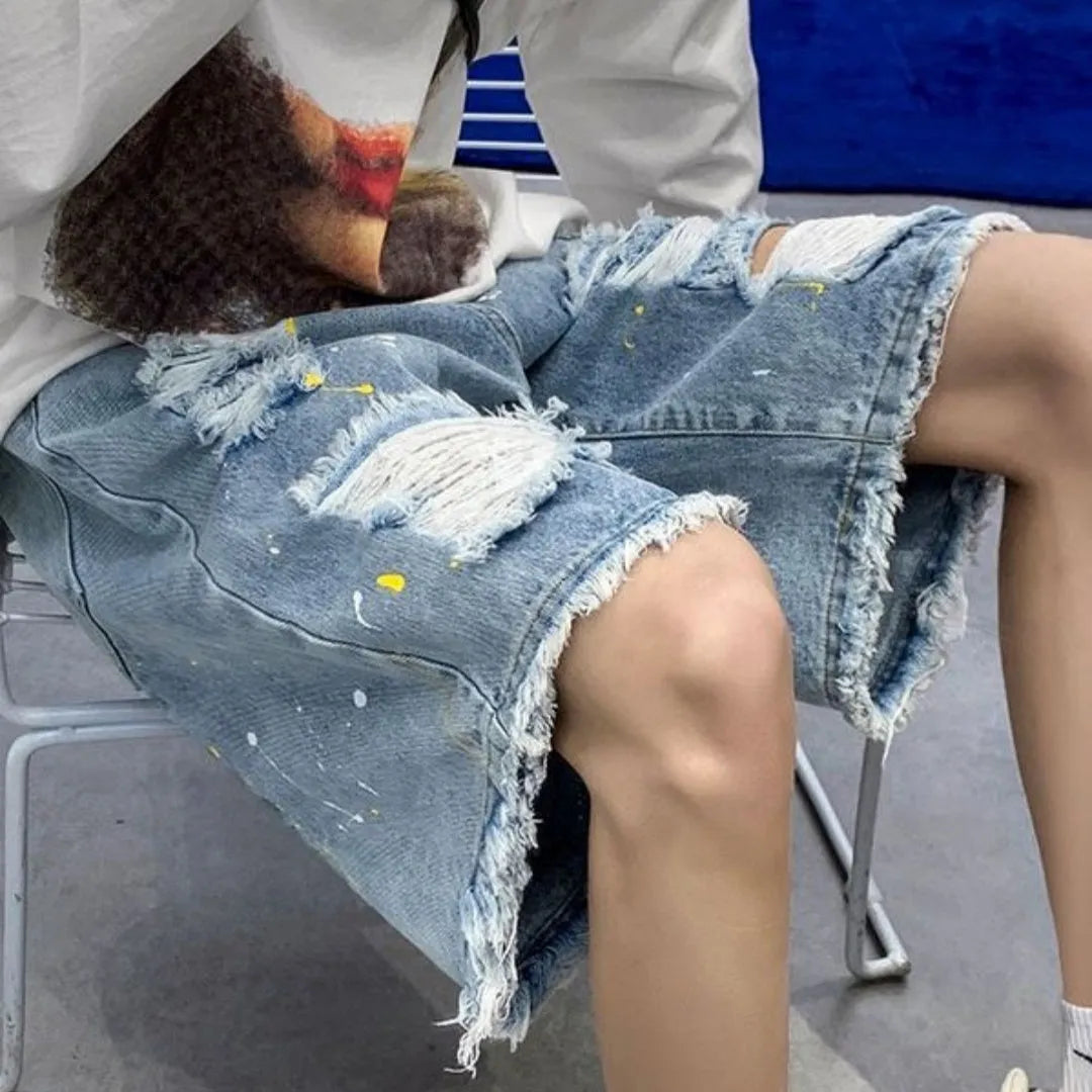 Men's water washed hole denim shorts in loose street style cut, available in black or light blue colours