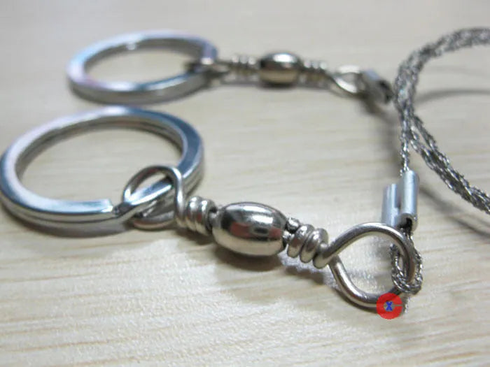 Survival wire saw with stainless steel blade and thumb rings for outdoor cutting tasks