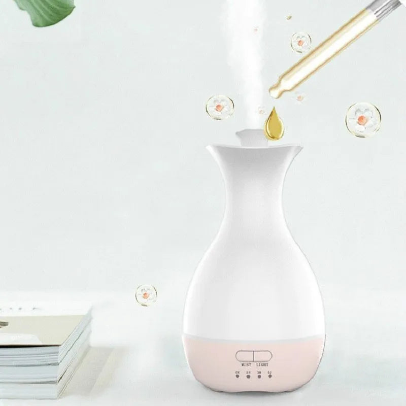 White ultrasonic aromatherapy humidifier with 200ml tank and colourful night light on wooden surface