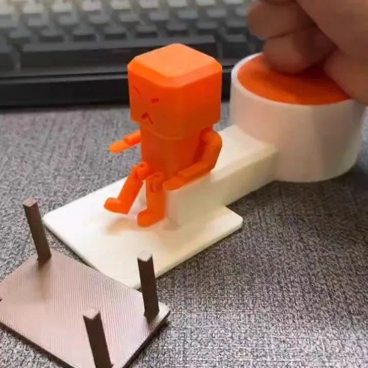 Orange plastic table turning decompression toy on desktop surface