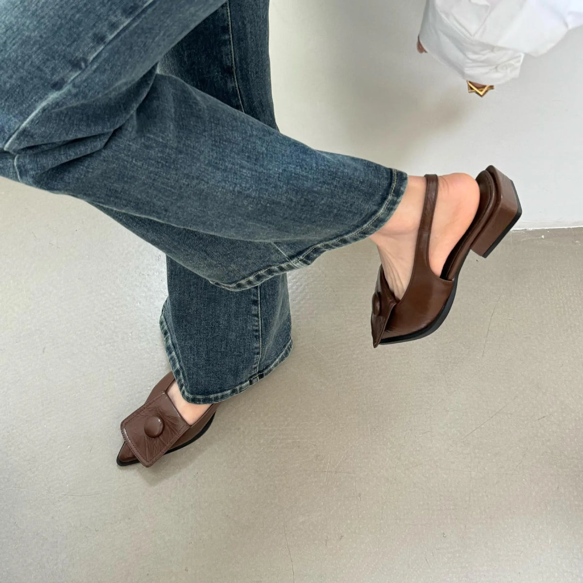 Women's low heel closed toe sandals in apricot with a pointed toe and back strap.