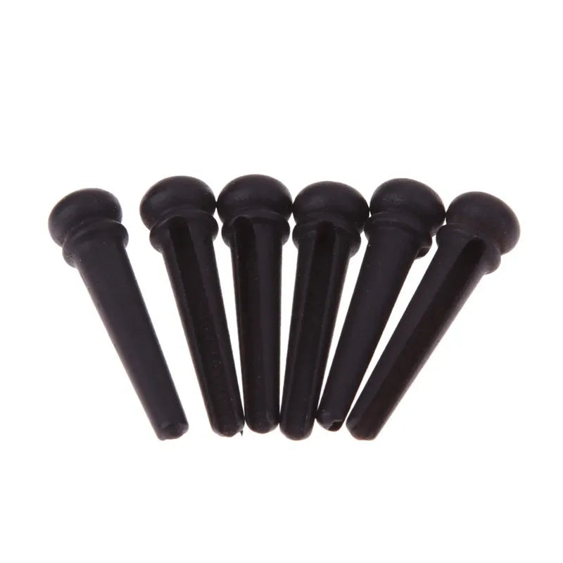 Six ebony folk guitar string nails with matt black finish and 5.3mm bayonet diameter