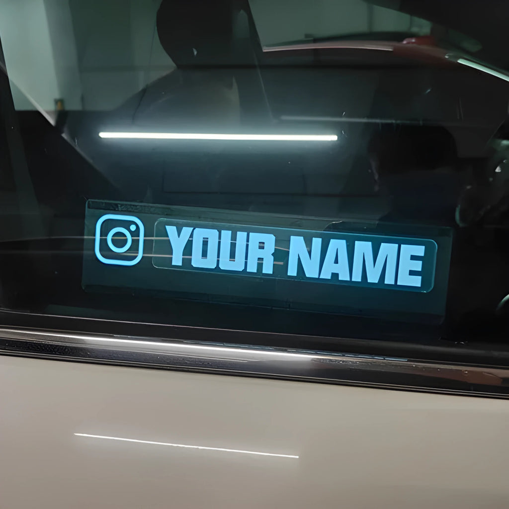 Illuminated car window sticker kit with thin 0.5mm decal showing soft white glow, includes driver and cable.