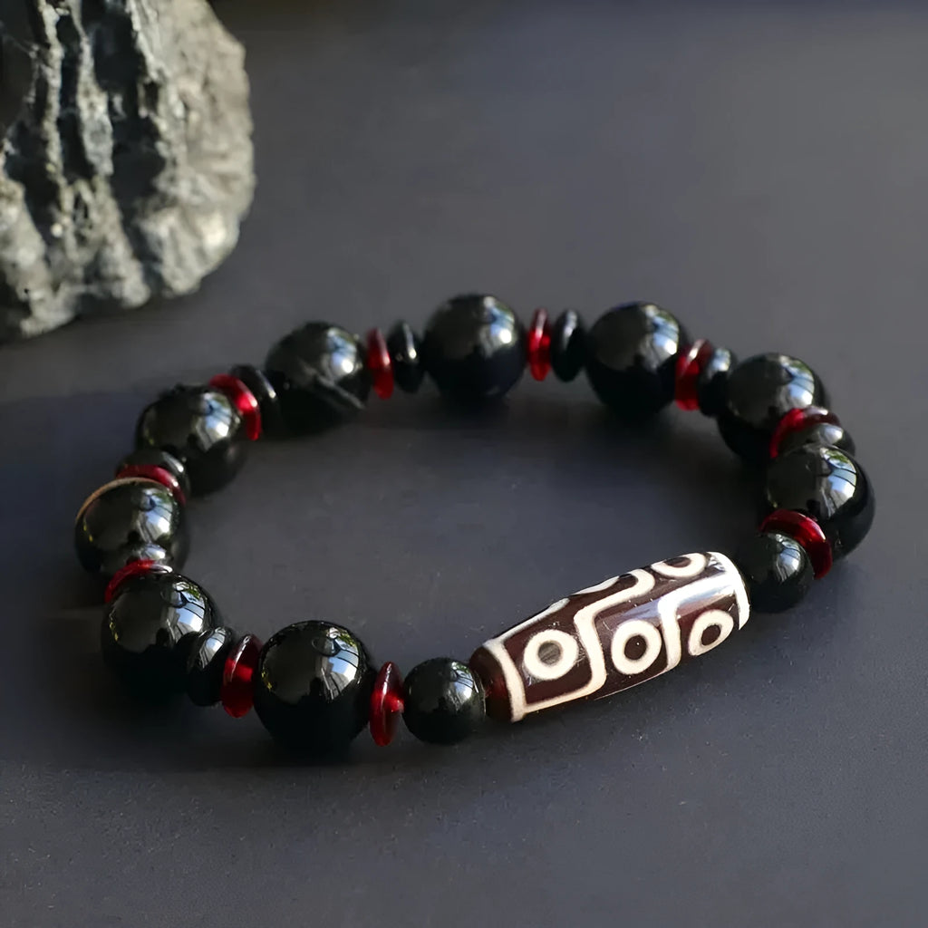Black agate dzi bead bracelet with hand-woven construction and geometric 11mm beads