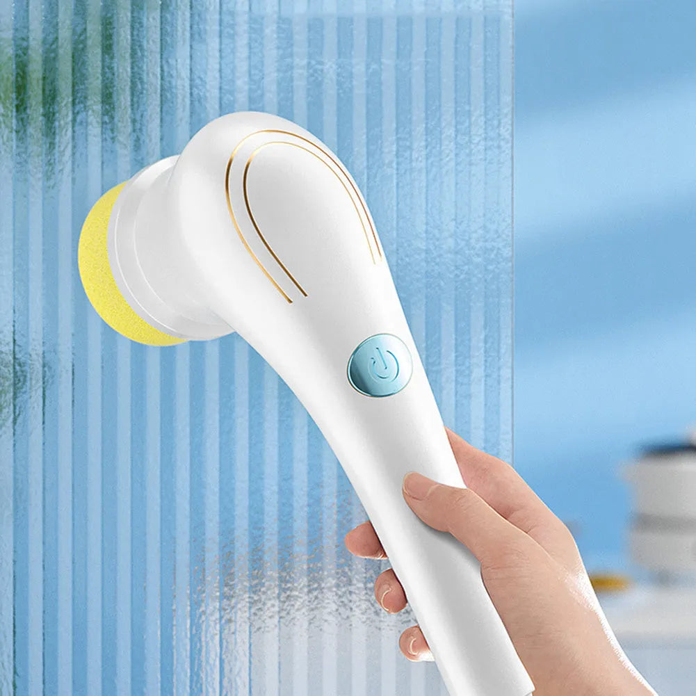 White cordless electric scrubber with five interchangeable brush heads on a kitchen counter