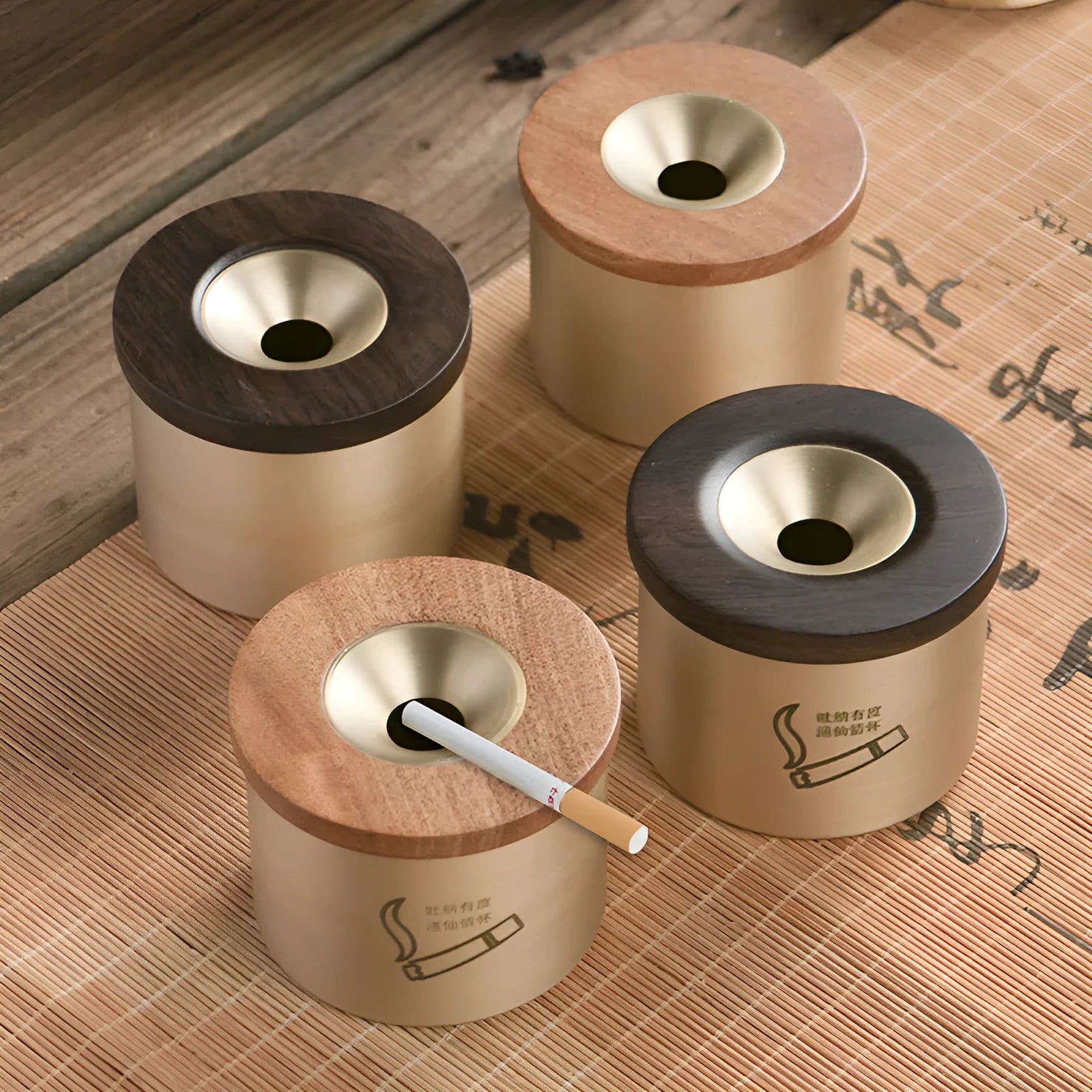 Retro-style solid copper ashtray with a wooden lid featuring a centre hole, shown in brass and black wood or brass and red wood.