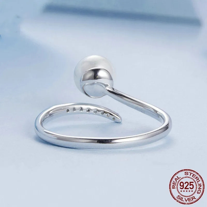 Sterling silver adjustable ring with shell pearls on open loop design