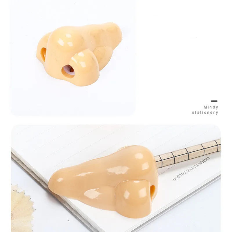 Flesh-coloured plastic geometry-shaped pencil sharpener with a large nostril.