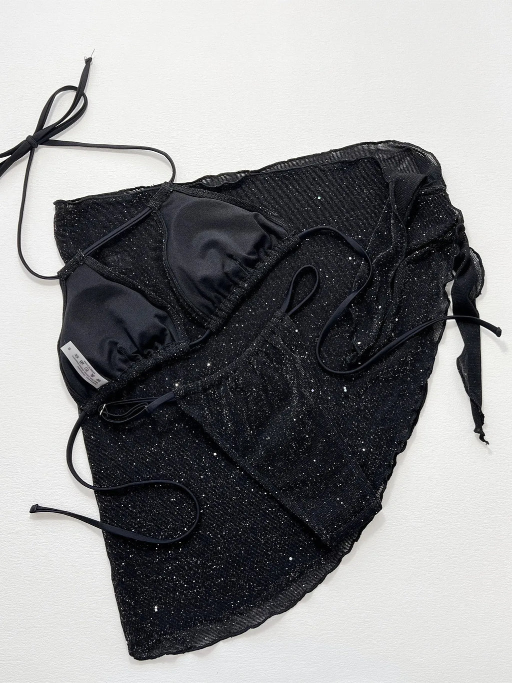 Black women's three-piece bikini swimsuit set with shorts on a mannequin