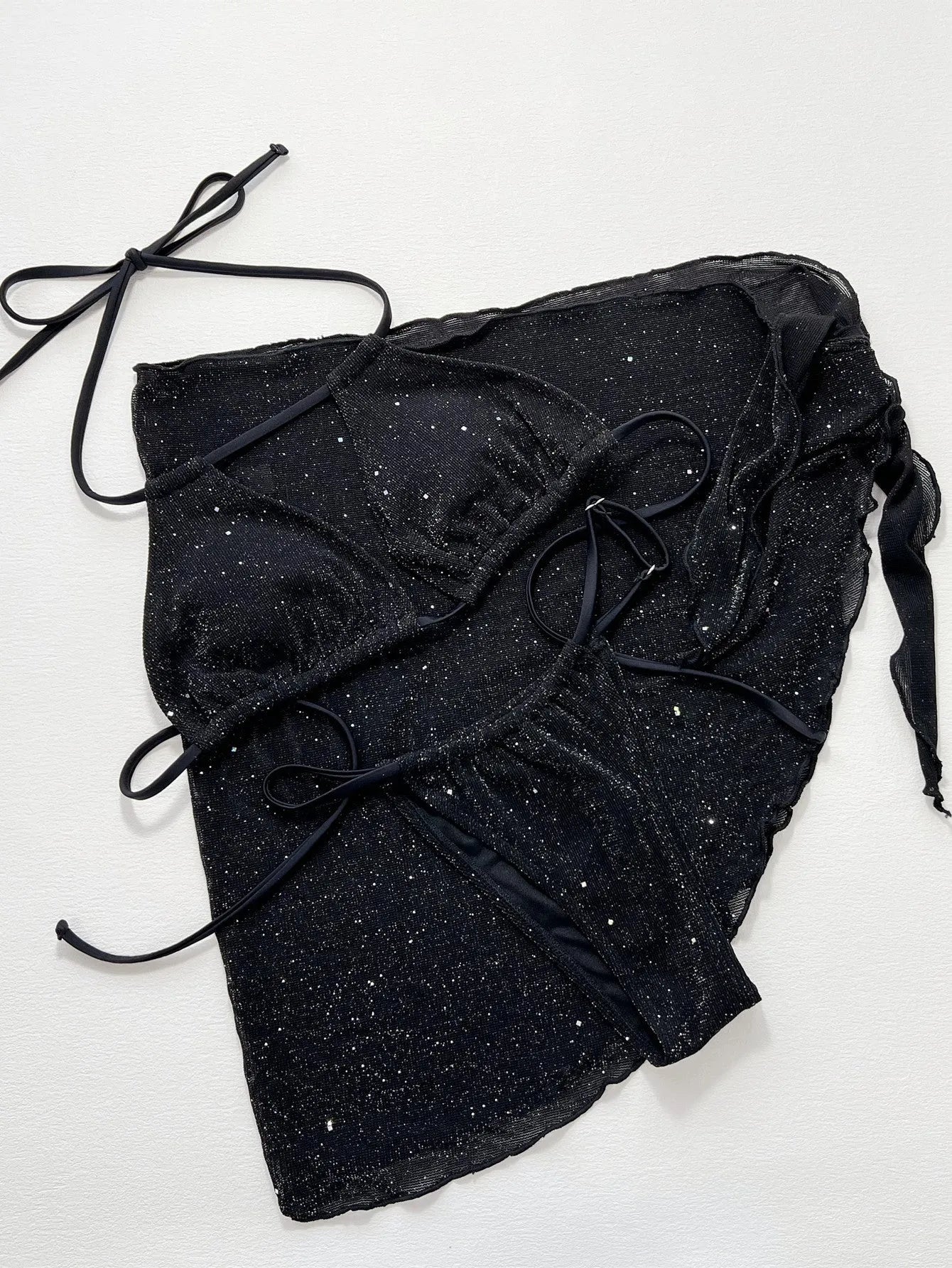 Black women's three-piece bikini swimsuit set with shorts on a mannequin