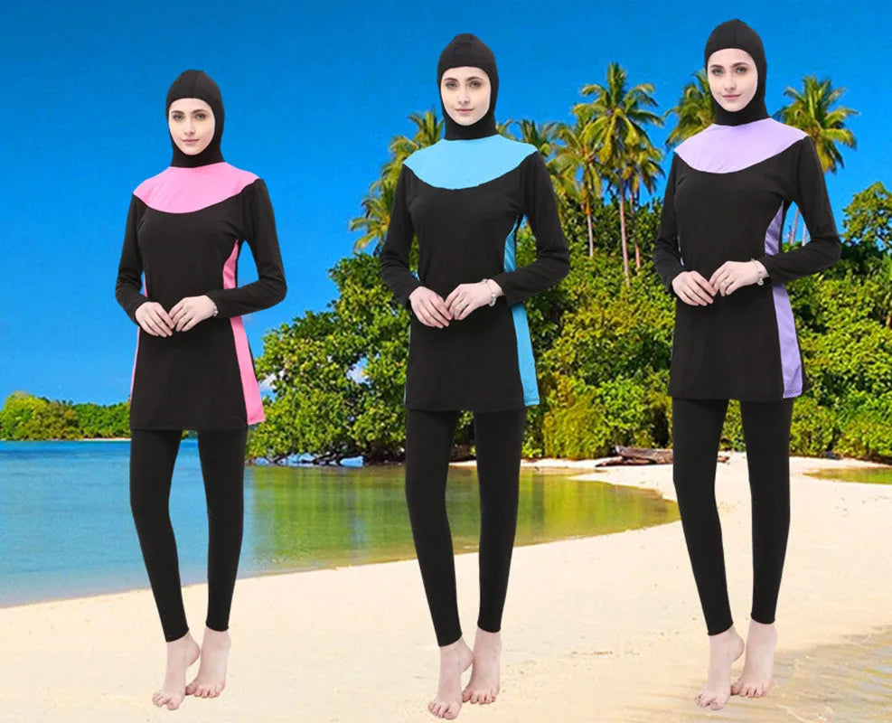 Women's conservative long sleeve hooded one-piece swimsuit in black with coloured accents.