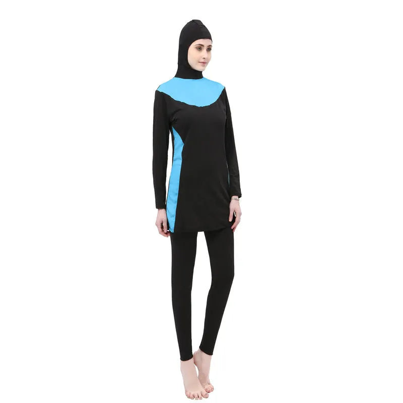 Women's conservative long sleeve hooded one-piece swimsuit in black with coloured accents.
