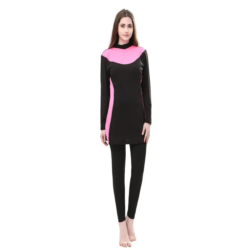 Women's conservative long sleeve hooded one-piece swimsuit in black with coloured accents.