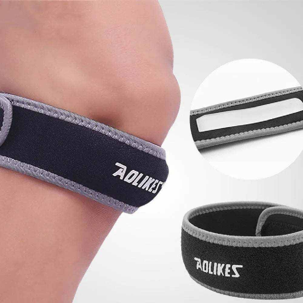 Black and grey adult patella retinaculum knee pad for sports protection.