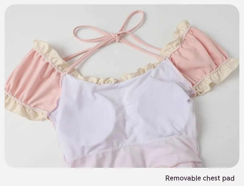 Women's pink one-piece swimsuit with conservative coverage and Siamese cat cute design