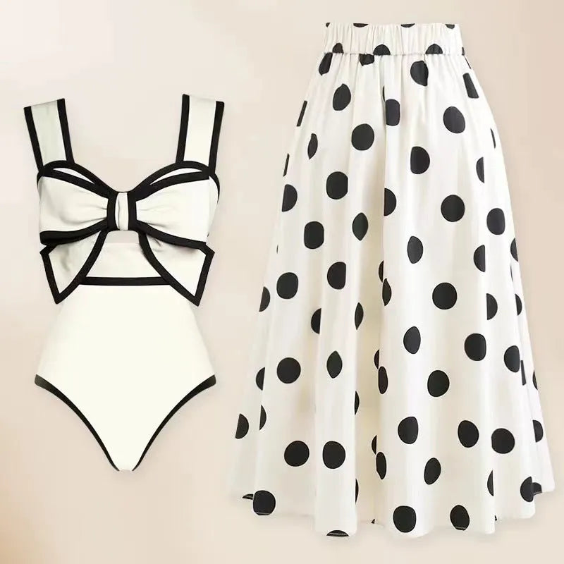 Women's black one-piece swimsuit with circular skirt and bow detail for beach and pool swimming