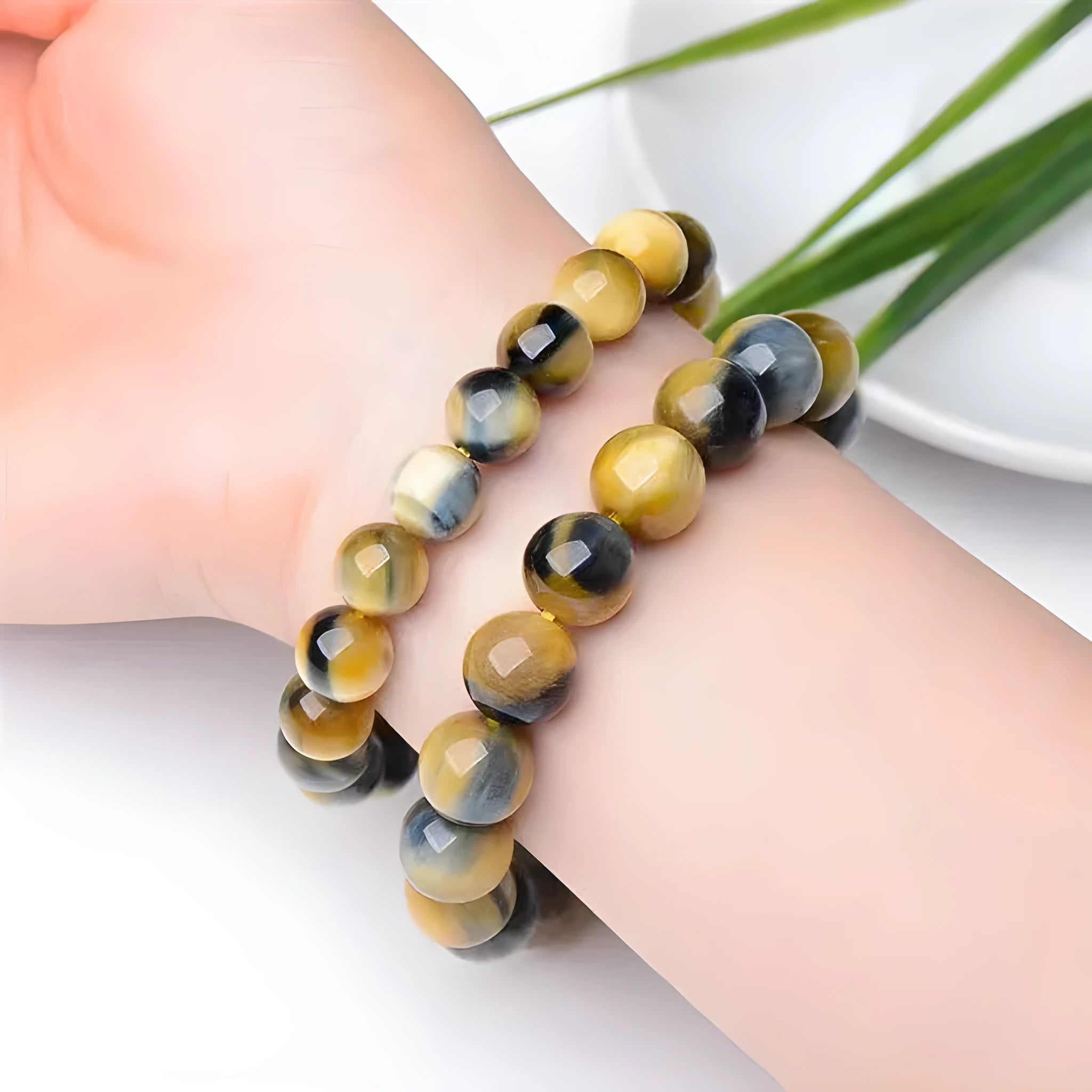 Handmade Fantasy Tigereye agate gemstone bracelet with round beads on a wrist.