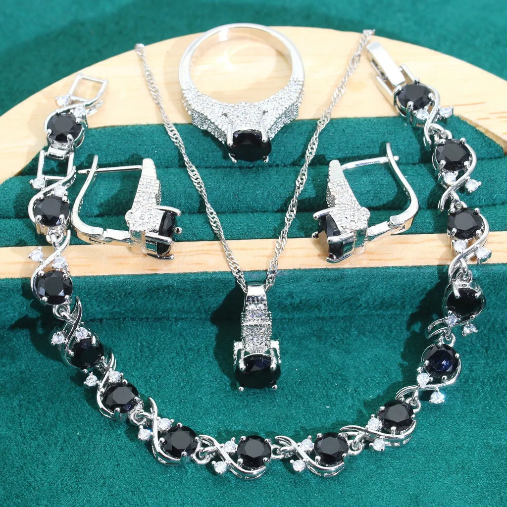 Bridal zircon necklace, bracelet, earrings, and ring four-piece jewellery set in alloy with water wave chain design.
