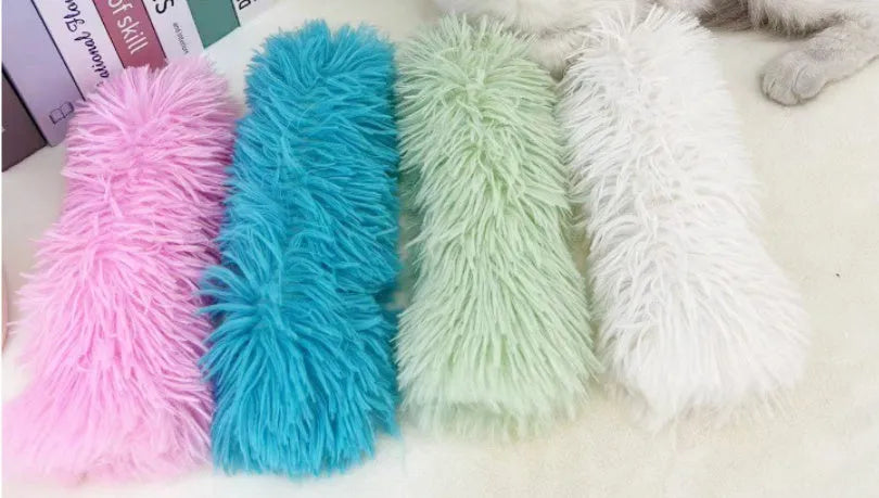 Plush cat toy pillow in blue, green, pink, or white colours measuring 27 by 10 centimetres