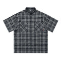 Men's black and brown plaid short sleeve shirt with embroidered lettering and lapel collar